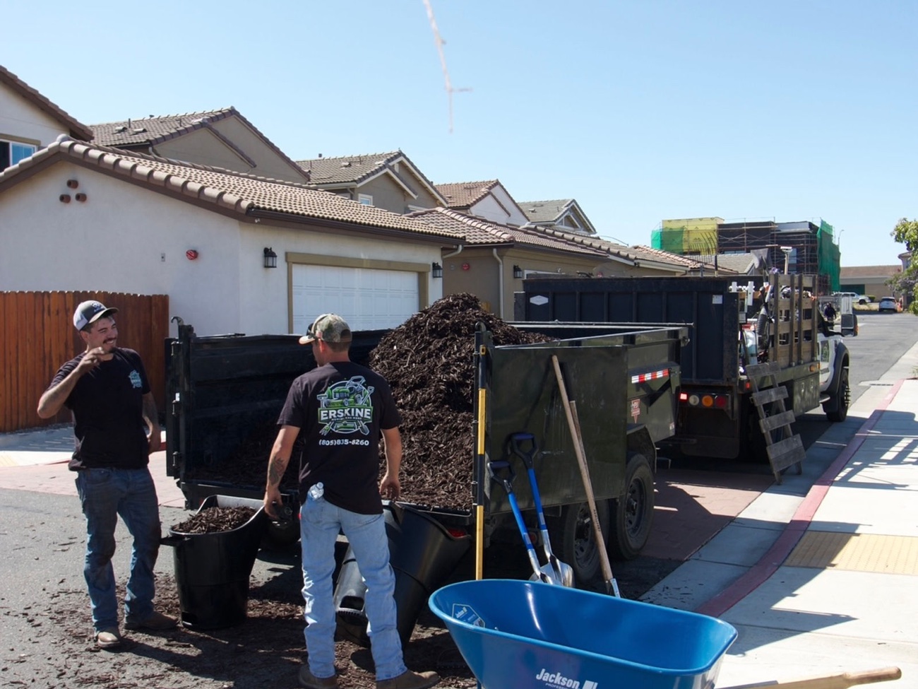 Erskine crew loading mulch into wheelbarrows